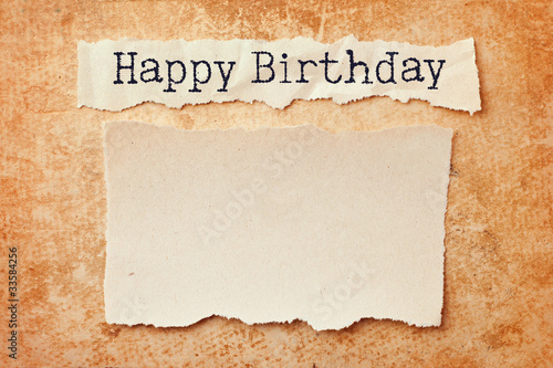 Paper with ripped edges on grunge paper background. Happy birthd photo