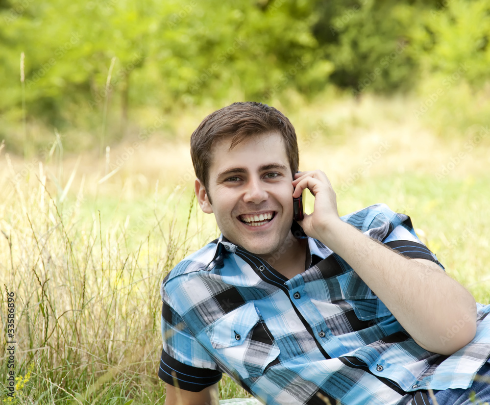 Smiling men with mobile phone at outdoor. Smiling men with mobile phone at outdoor.