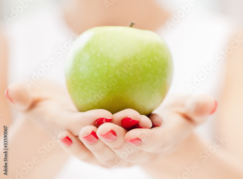female hands with green apple