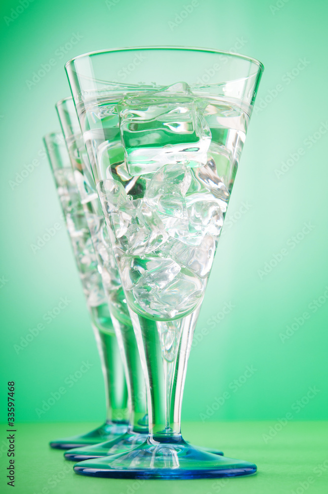 Water in the glass against gradient background Water in the glass against gradient background