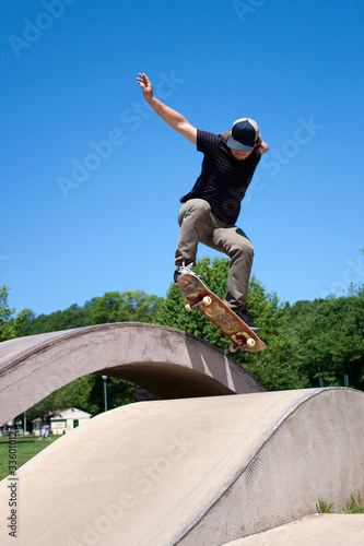 Skateboarder Doing a Jump at a Concrete Skate Park