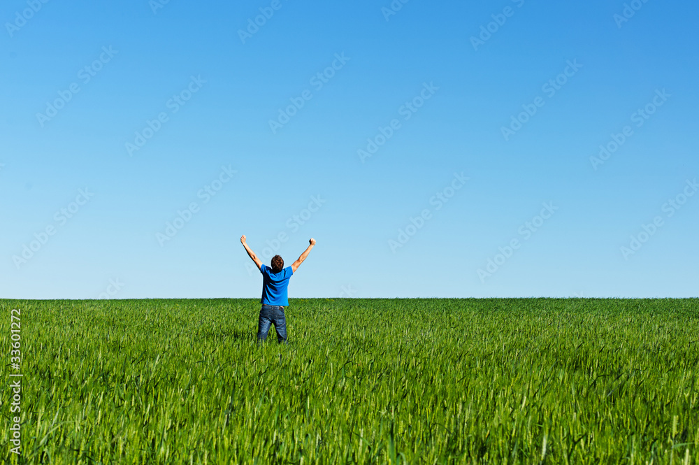 happy man standing on green meadow happy man standing on green meadow