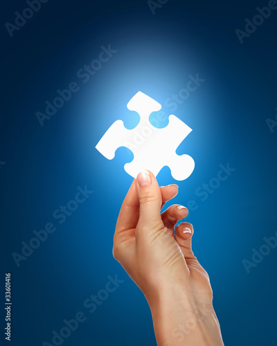 human hand with a piece of puzzle