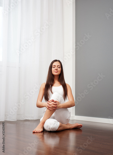 woman doing yoga exercise on floor