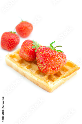Waffles and strawberries isolated on white