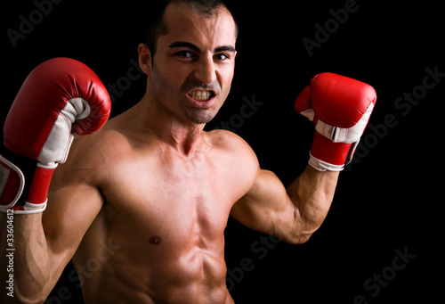 Young Boxer fighter over black background © cristovao31