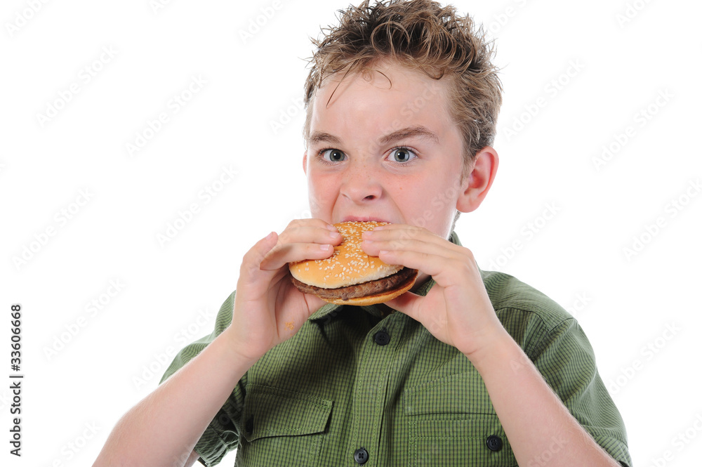 Little boy eating a hamburger