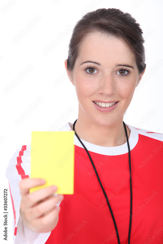 Female referee holding yellow card Female referee holding yellow card