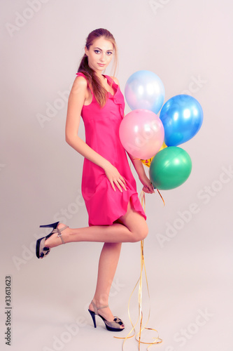 beautiful young girl with balloons on gray background © Africa Studio