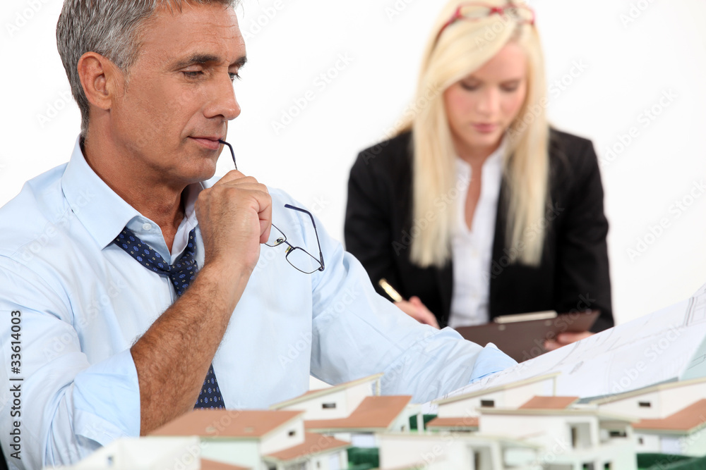 Architect with plans and 3D model Architect with plans and 3D model