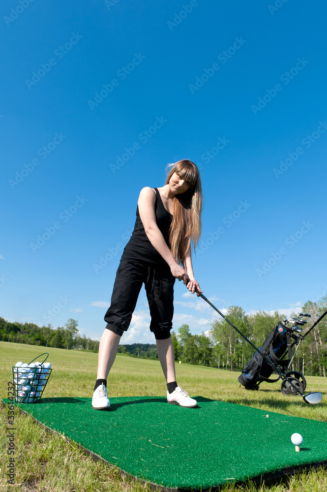 Woman about to strike golf ball