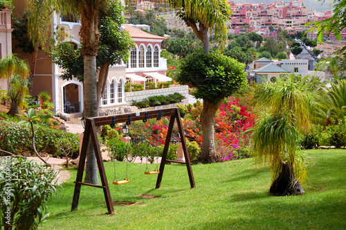 Swing on the green lawn at luxury hotel, Tenerife island, Spain photo