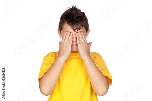 Funny child with yellow t-shirt covering eyes