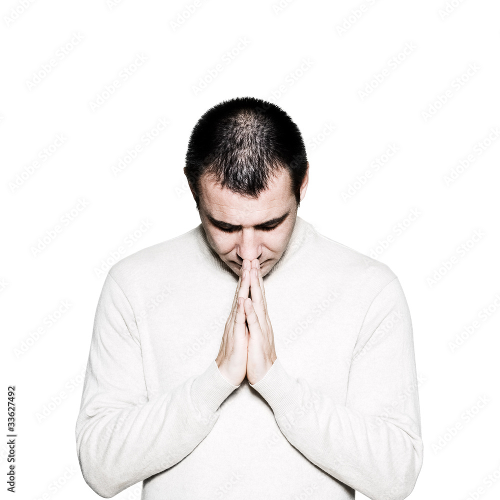 Man with hands clasped praying