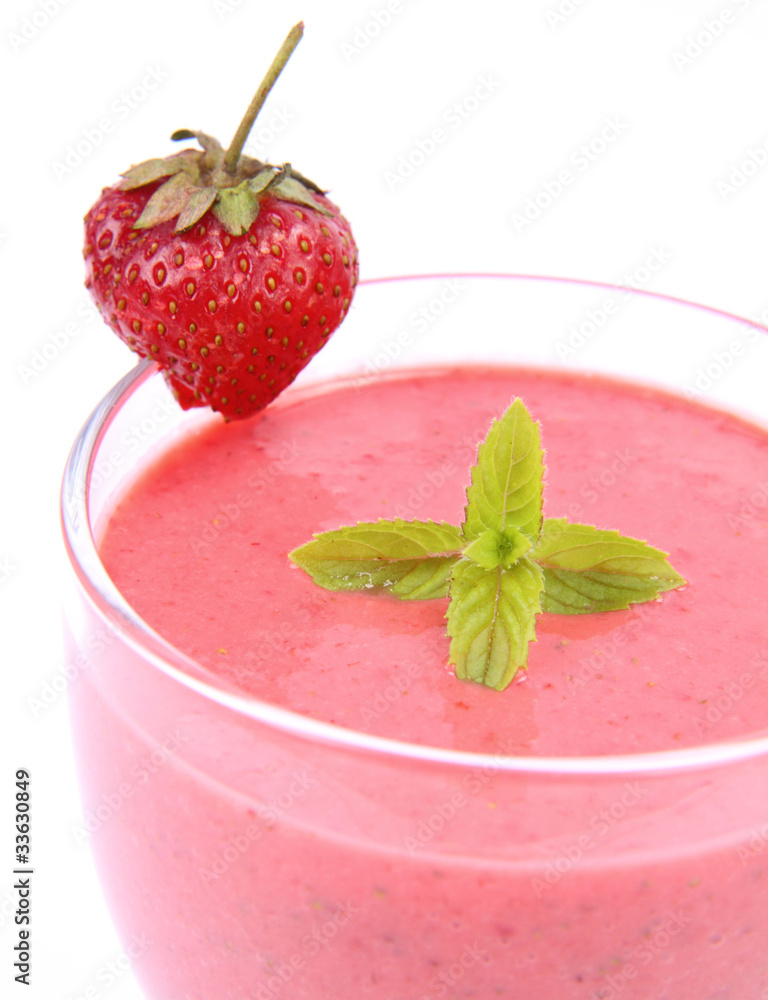 Strawberry shake in a glass with a strawberry and mint Strawberry shake in a glass with a strawberry and mint