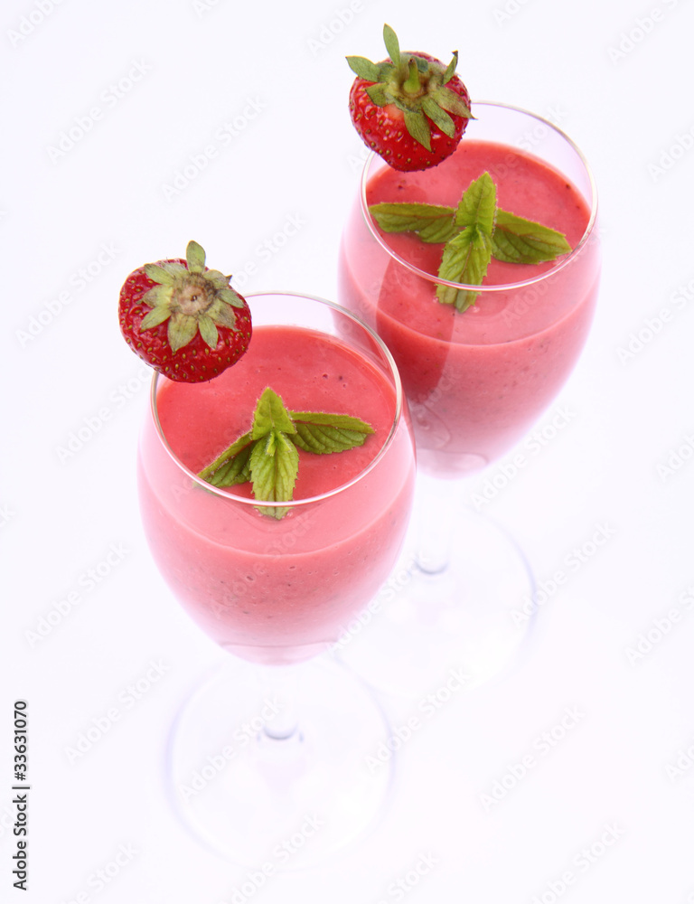 Strawberry shake in champagne glasses with strawberry and mint Strawberry shake in champagne glasses with strawberry and mint