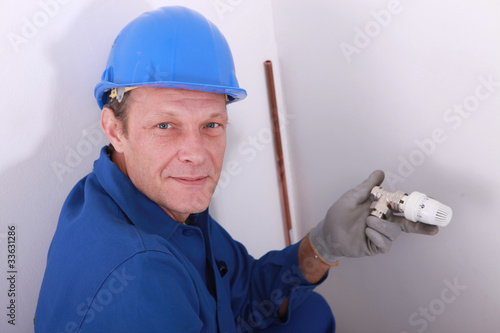 Plumber with a thermostatic radiator valve photo
