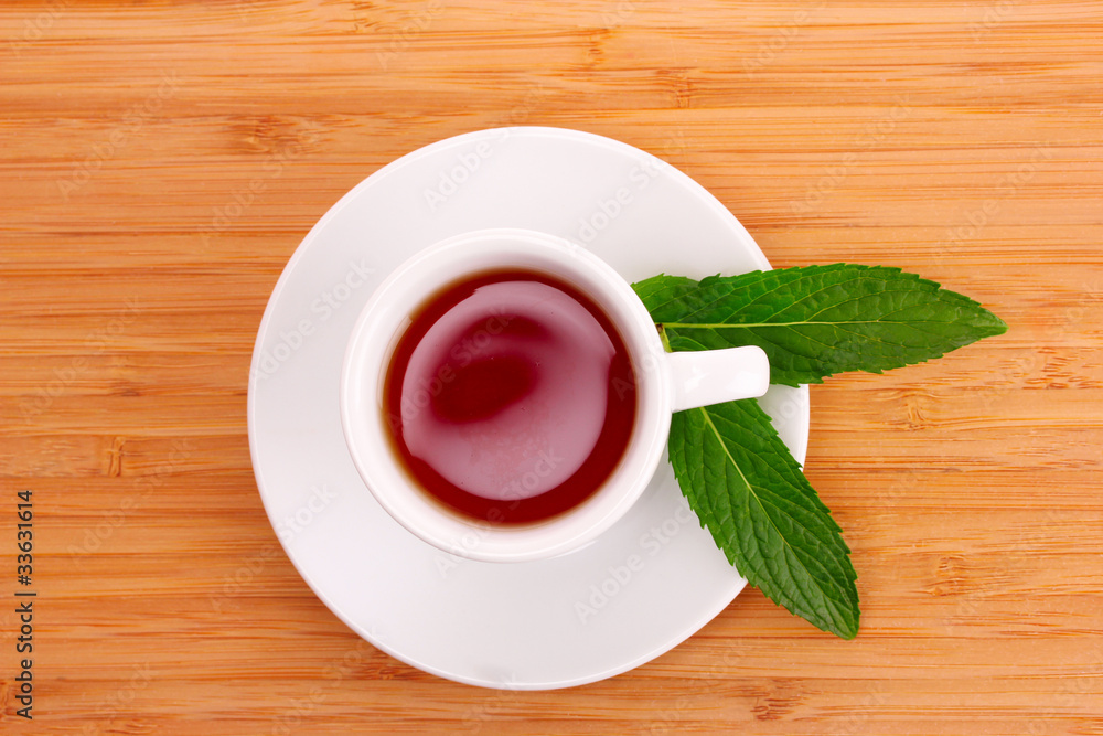 Obraz premium Cup with mint on wooden background