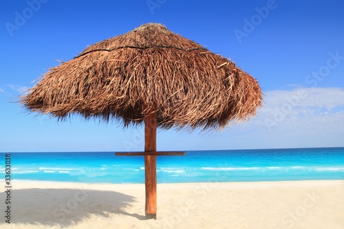 palapa sun roof beach umbrella in caribbean © lunamarina