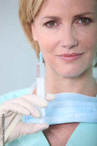 Female nurse holding syringe