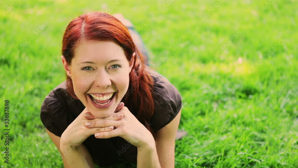 Redhaired girl having fun on grass Redhaired girl having fun on grass
