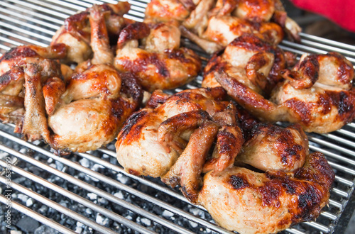 Fresh barbecue chicken on open grill