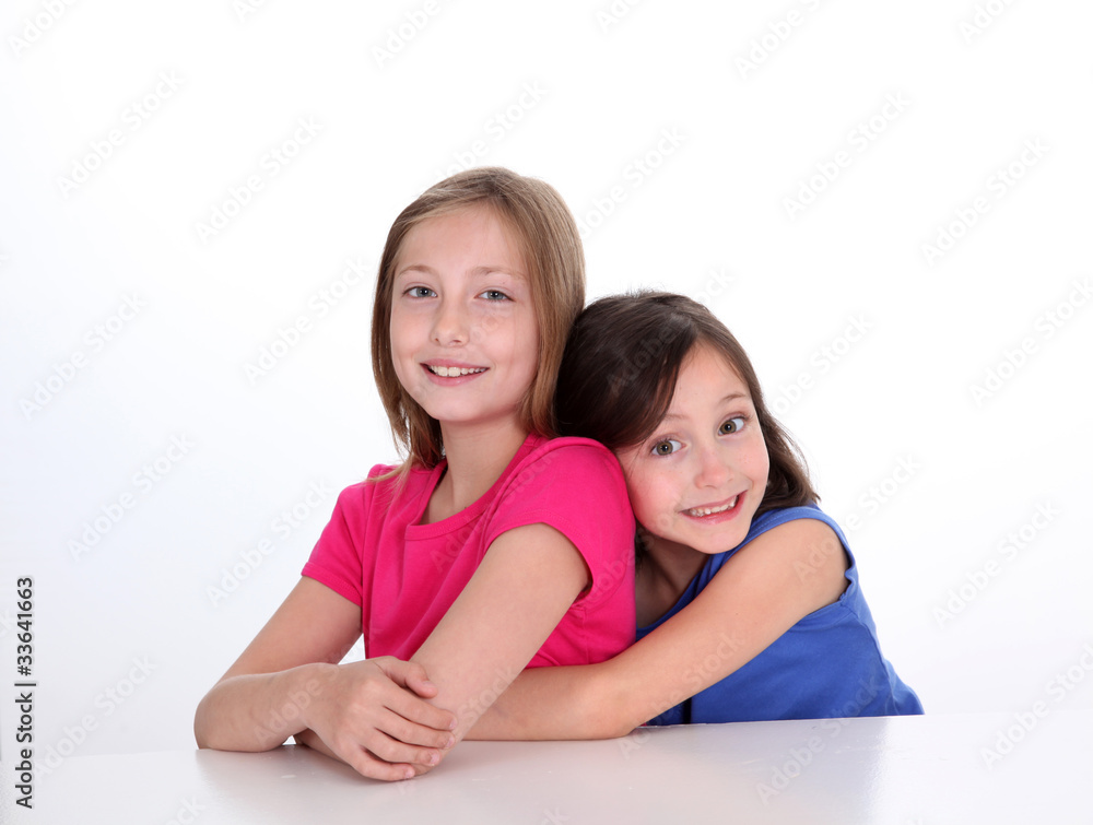Portrait of young sisters showing complicity Portrait of young sisters showing complicity