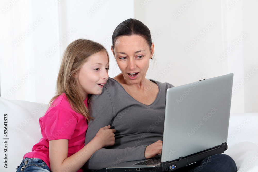 Mother and daughter using laptop computer at home Mother and daughter using laptop computer at home