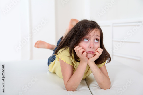 Portrait of little girl with bored expression © goodluz