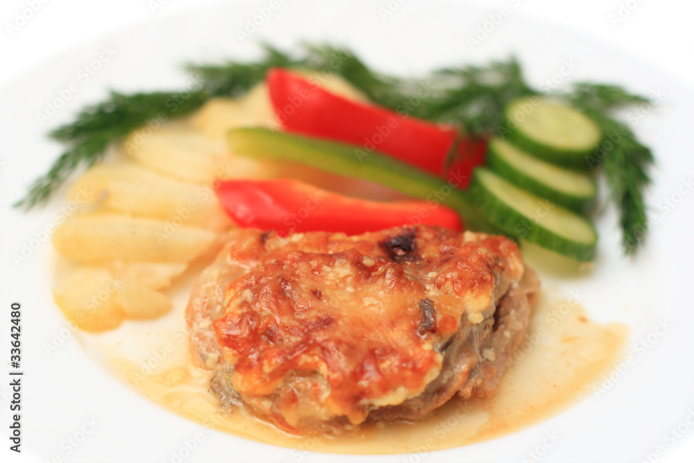 Piece of meat with vegetables on a white plate Piece of meat with vegetables on a white plate
