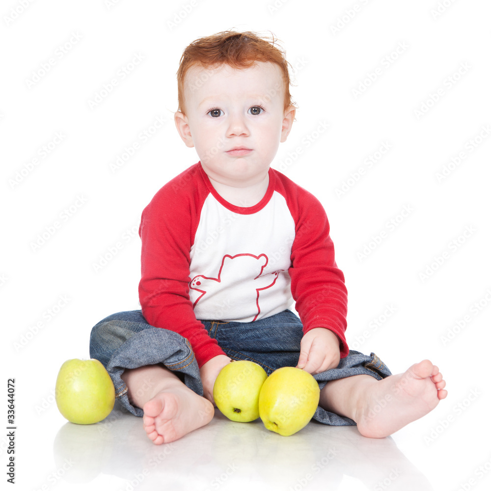 Baby boy sitting with green apples Baby boy sitting with green apples