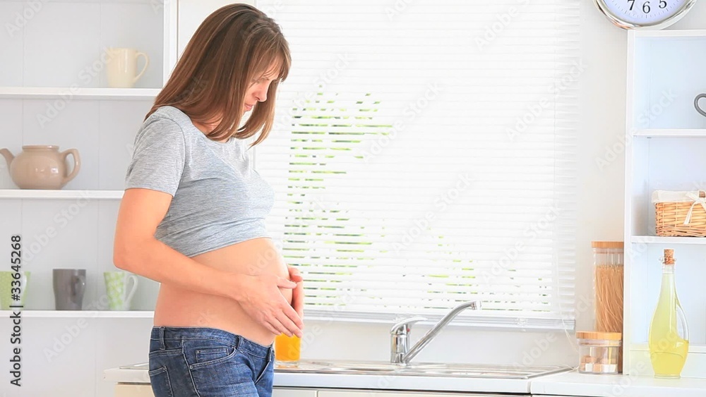 Pregnant woman holding her tummy Pregnant woman holding her tummy
