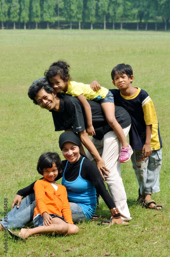 An asian family psoing together in outdoor scene An asian family psoing together in outdoor scene