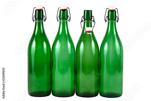 Four Empty Green Glass Bottles Isolated on White Background