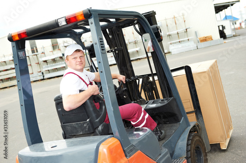 warehouse worker driver in forklift