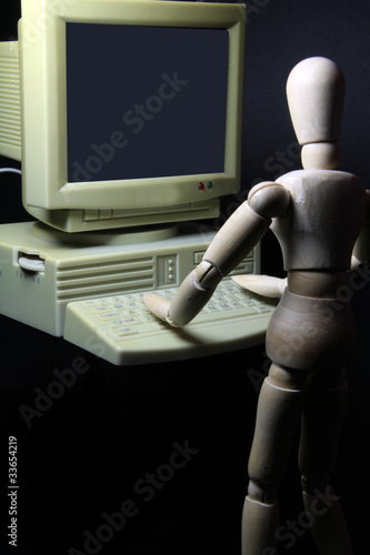 humanoid working on an old PC