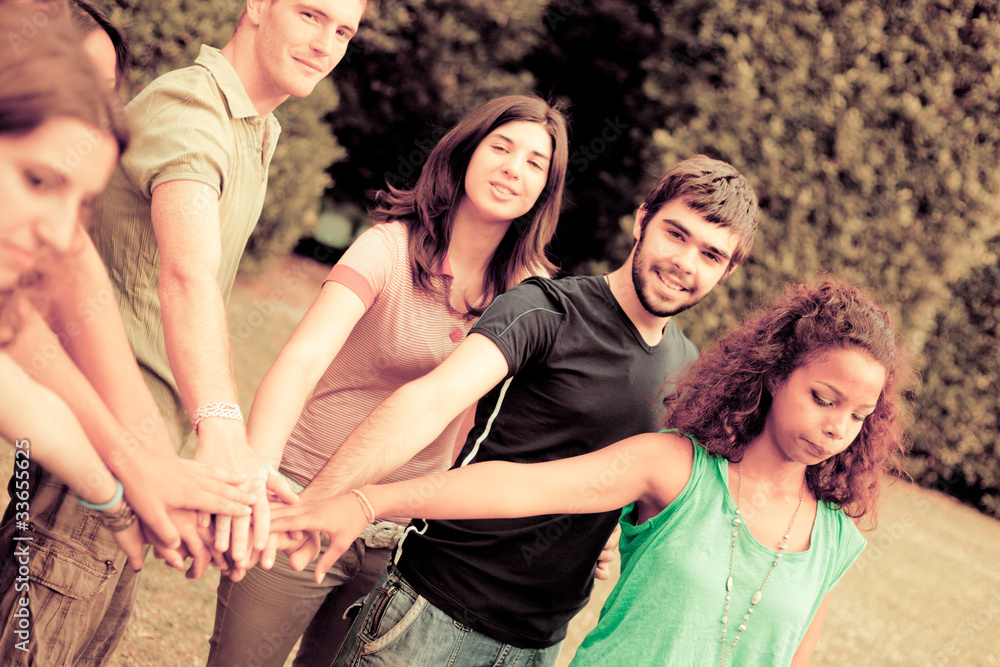 Happy Teenage Group with Hands on Stack Happy Teenage Group with Hands on Stack