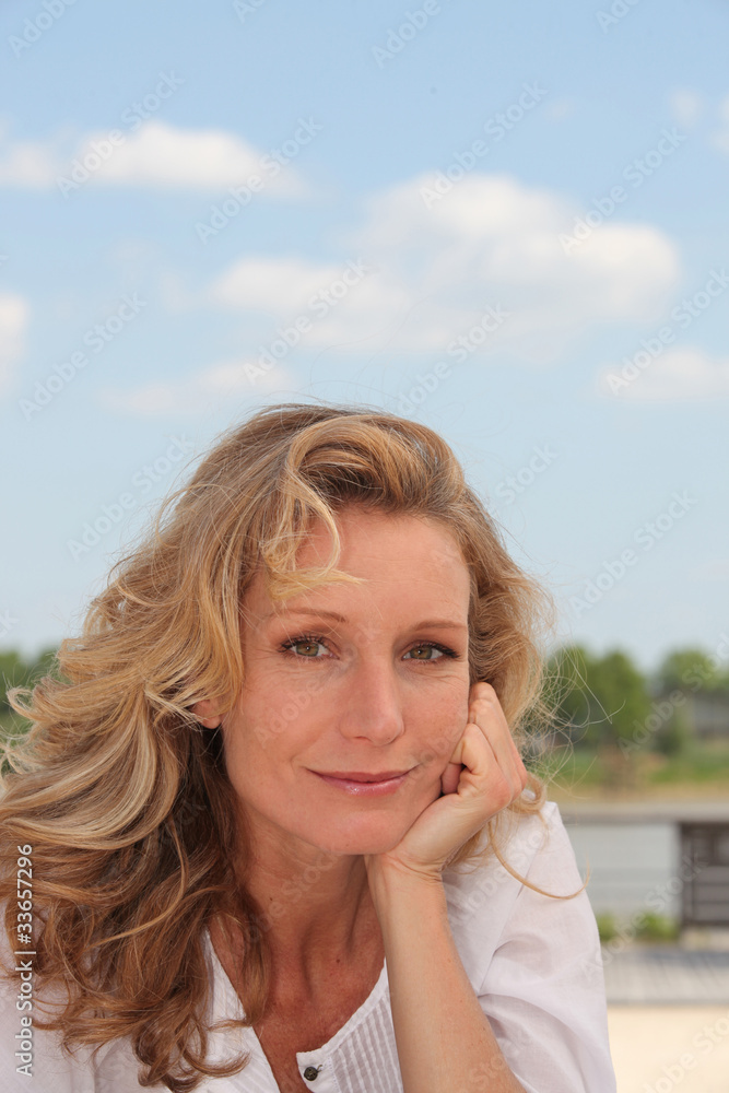 Portrait of blond woman outdoors on a sunny day