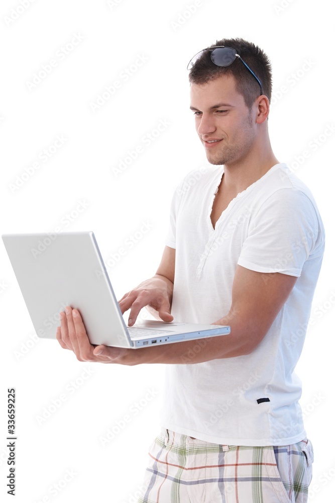 College student using laptop smiling College student using laptop smiling