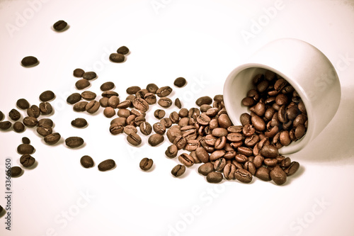 fallen cup with coffee beans scattered