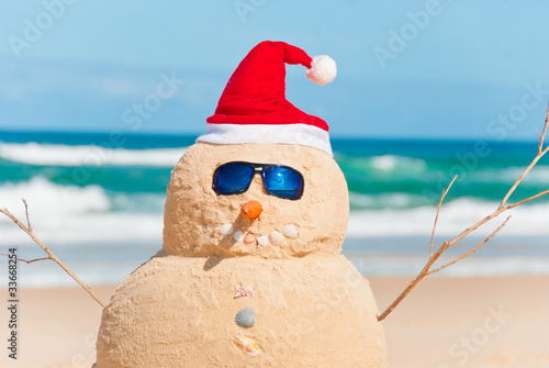 Snowman Made Out Of Sand With Santa Hat