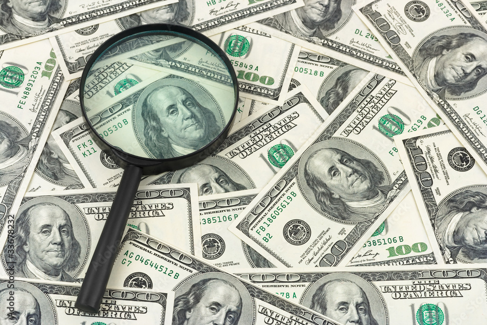 Magnifying glass and money
