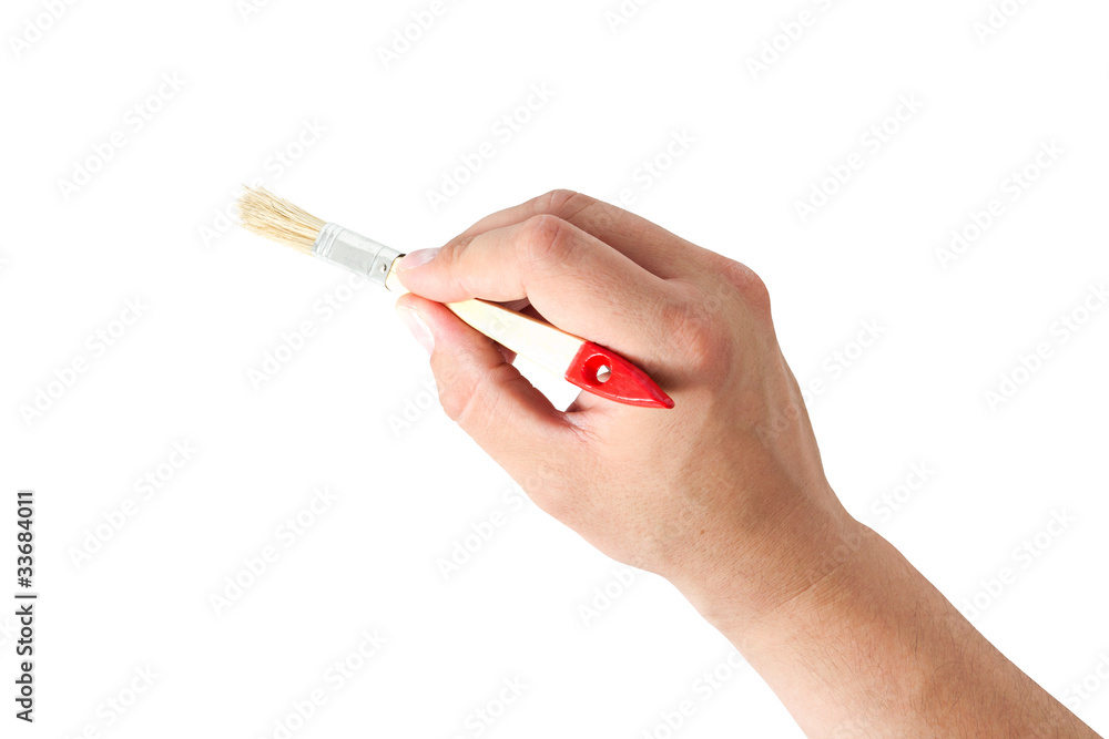 hand holding a brush hand holding a brush