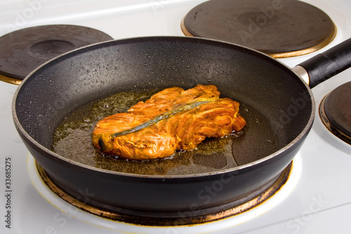 Frying pan with salmon steak