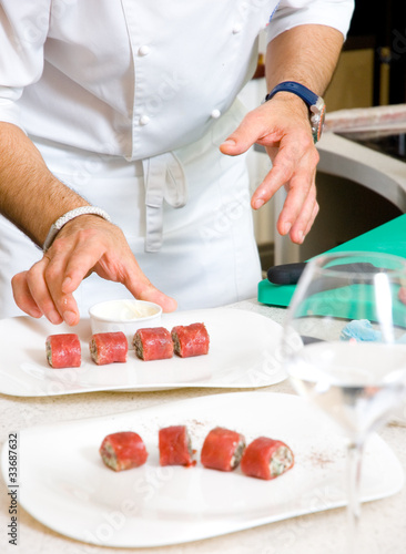 Chef decorate plate with food