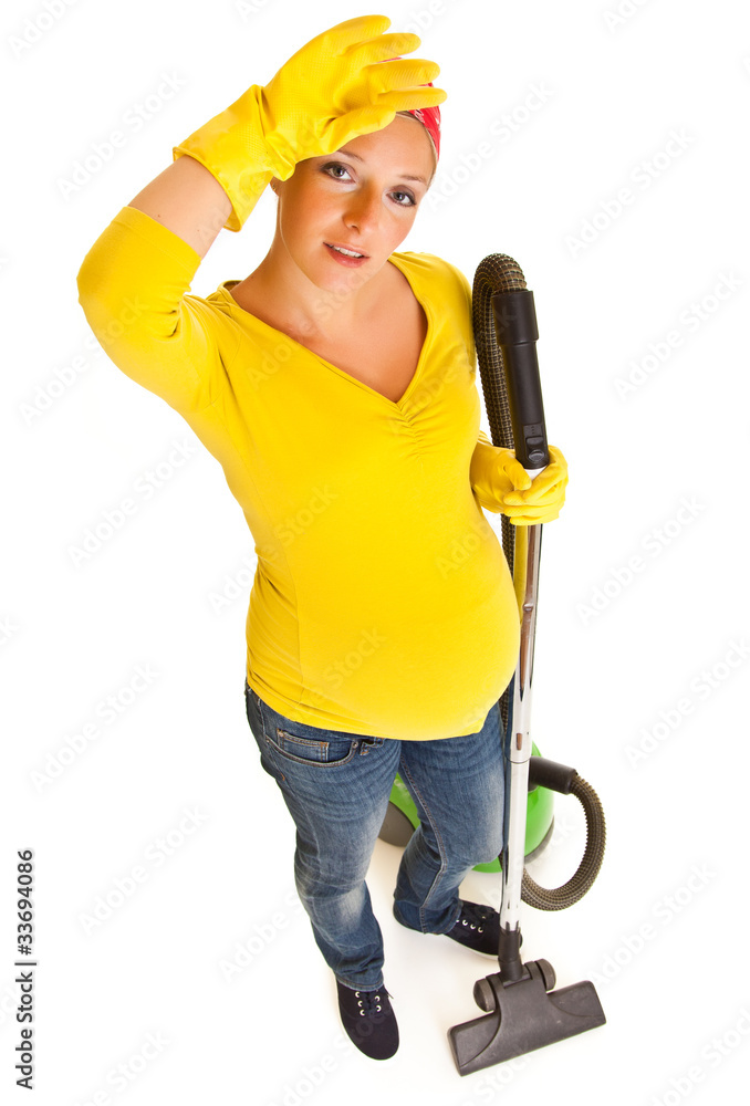 Pregnant woman clean with vacuum cleaner isolated on white Pregnant woman clean with vacuum cleaner isolated on white
