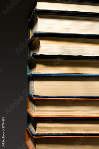 Stack of books isolated on the dark background