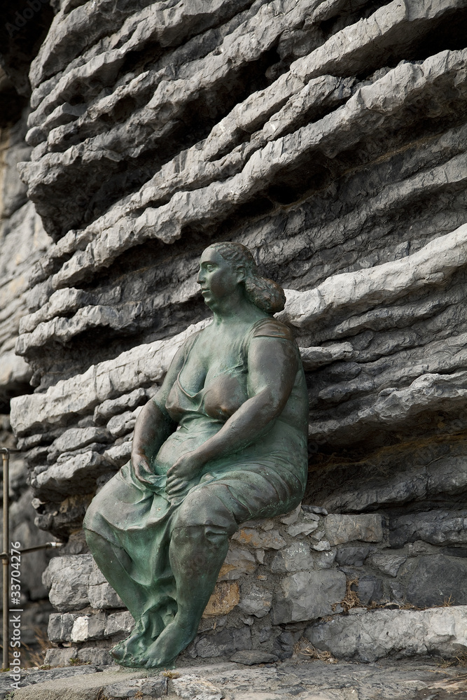 Bronze statue on the rock Bronze statue on the rock