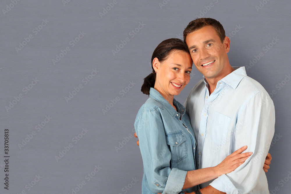 Portrait of couple standing on grey background Portrait of couple standing on grey background