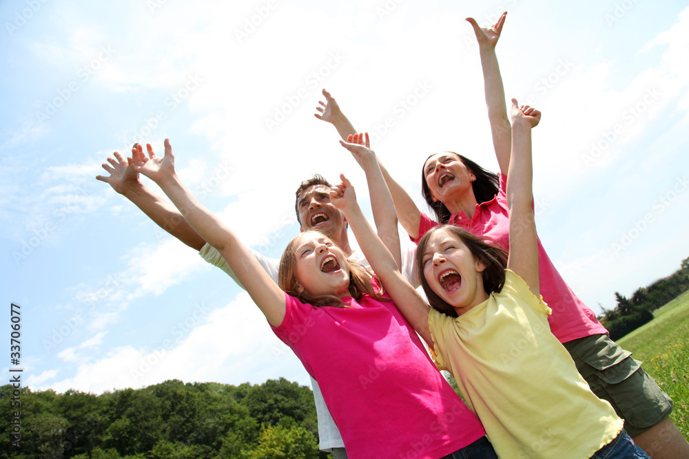 Cheerful family lifting arms up in the air Cheerful family lifting arms up in the air